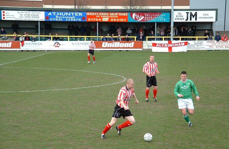 Tom Peers of Altricham in action with Claudio Ofosu of Hartlepool